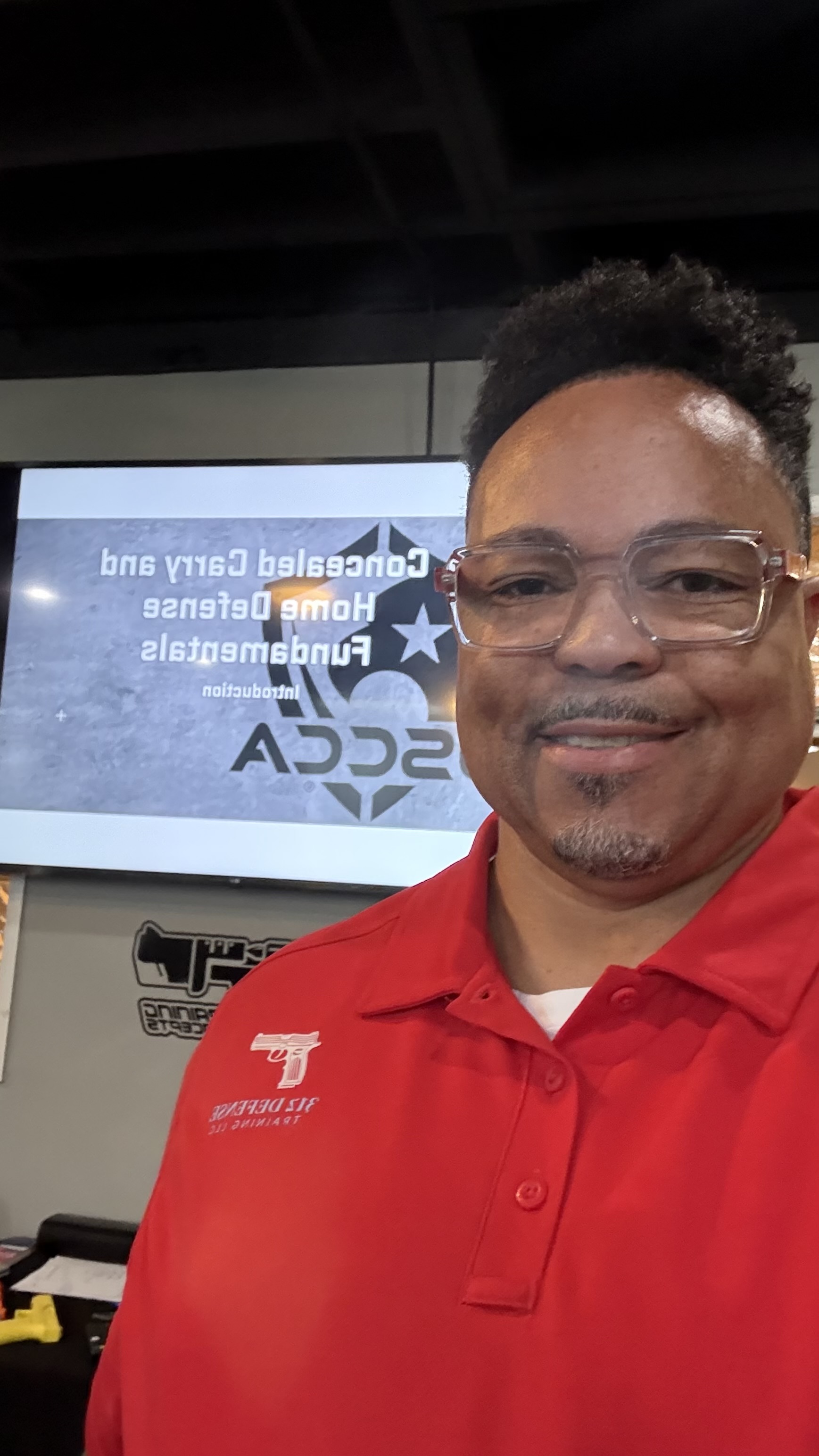 312 Defense instructor in red training shirt