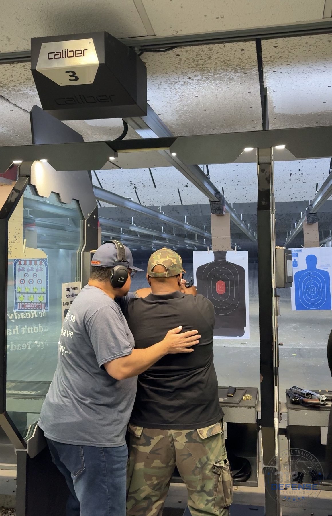 Firearms instructor coaching a student during live-fire handgun training