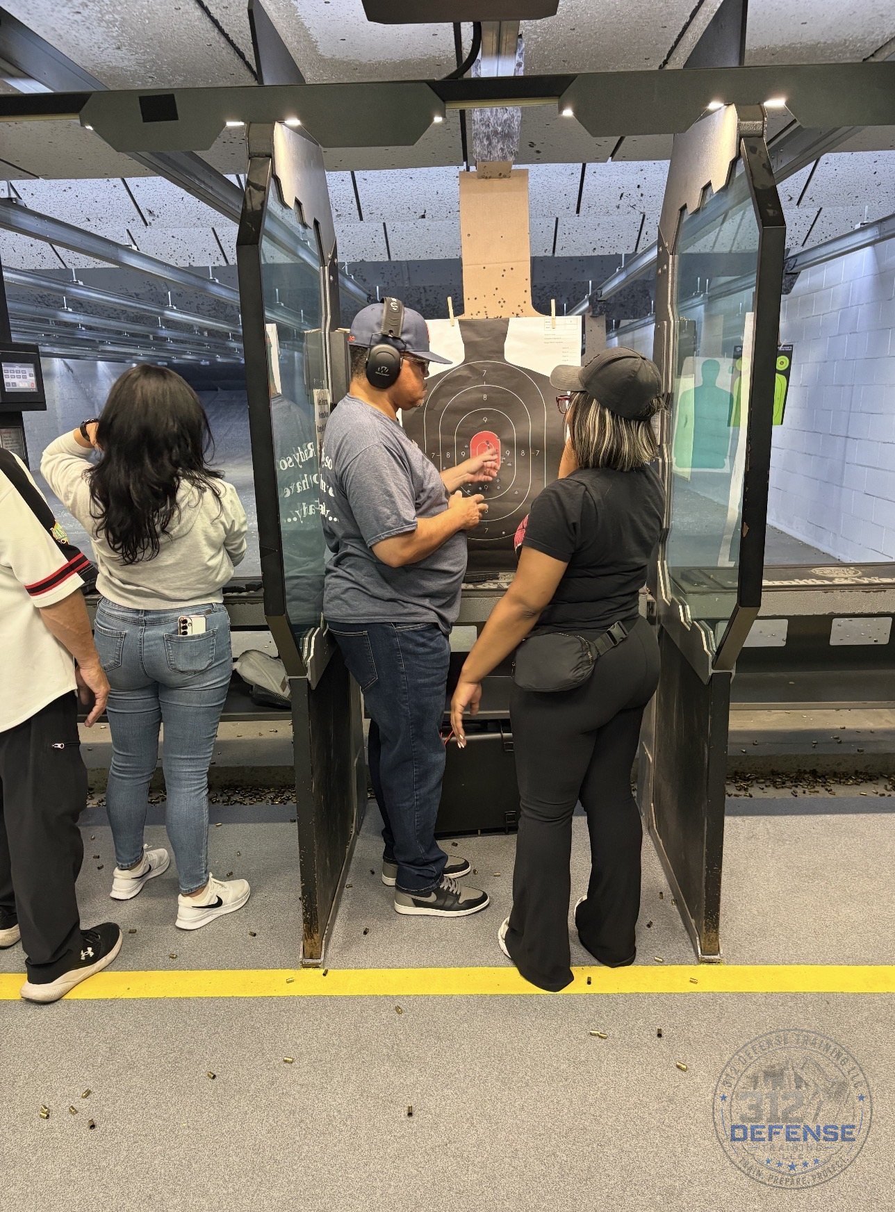 Instructor reviewing a student's target during firearms training